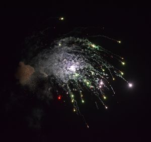 Low angle view of firework display at night