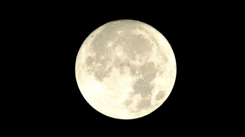 Low angle view of moon against clear sky at night