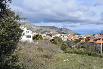 Buildings in town against sky