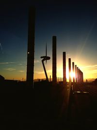 Silhouette buildings against sky during sunset