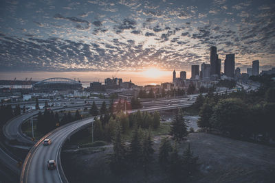 Aerial view of city against cloudy sky