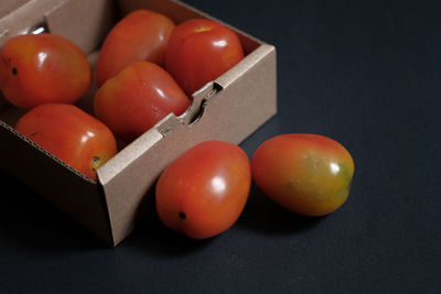 High angle view of tomatoes on table against black background