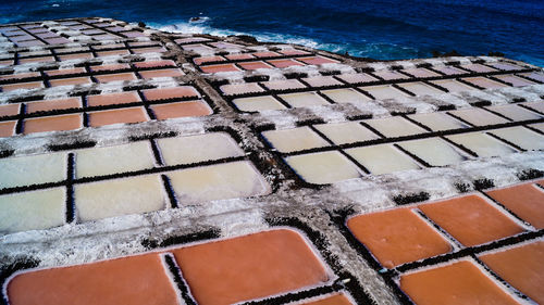 High angle view of salt flat sea salk farm water fields multicolour texture background 