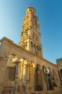 Low angle view of historic building against clear blue sky