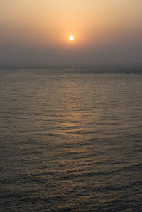 Scenic view of sea against orange sky