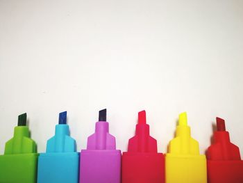 Close-up of colored pencils over white background