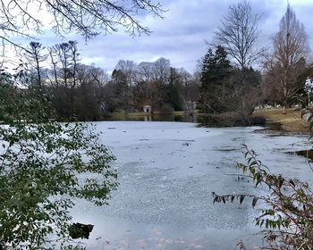 Scenic view of frozen lake against sky during winter