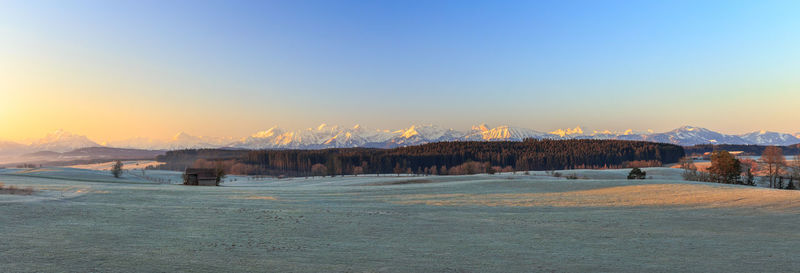 Scenic view of snow covered mountain against sky during sunset