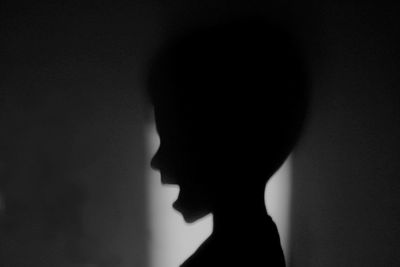 Silhouette of woman against black background