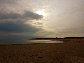 Scenic view of beach against sky during sunset