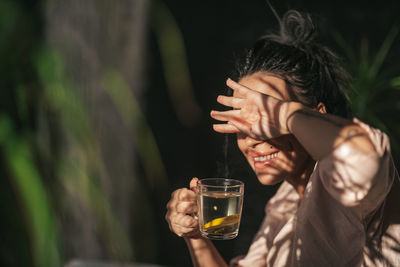 Full length portrait of a man drinking glass