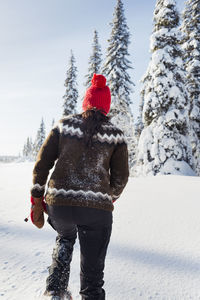 Woman walking through snow