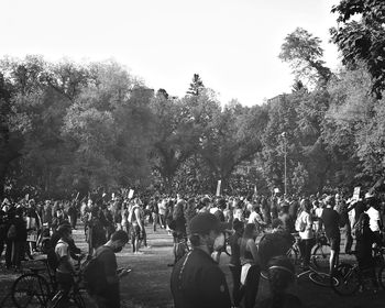 Group of people in city against clear sky