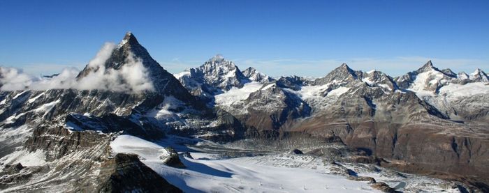 Scenic view of snow covered mountains against sky