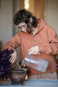 Midsection of woman holding potted plant