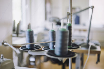 Thread spools on sewing machine at workshop