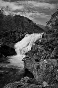 Scenic view of waterfall against sky