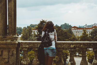 Rear view of woman standing against sky