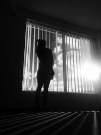 Woman standing by window