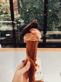 Cropped hand holding ice cream cone