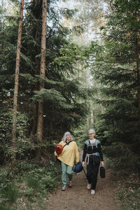 Two senior women hiking in forest