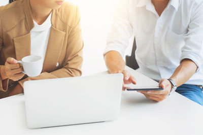 Rear view of people working in laptop