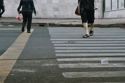 Low section of people walking on road