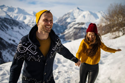 Young couple in love enjoying on winter vacation together on the mountain