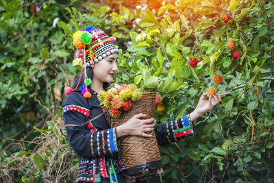 Girl holding ice cream by plants