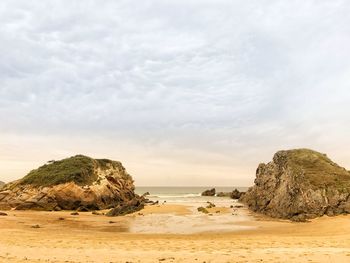 Rocks on beach against sky