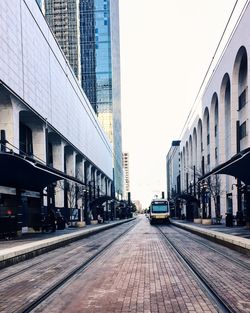 Cars on city street against clear sky