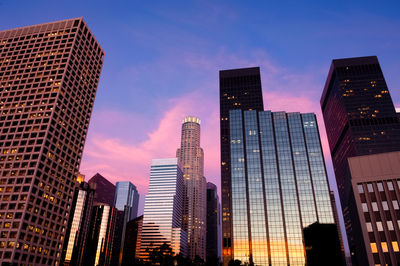 Low angle view of buildings against sky during sunset