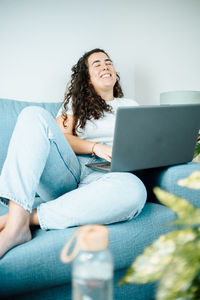 Young woman using laptop at home