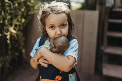 Portrait of cute girl holding toy