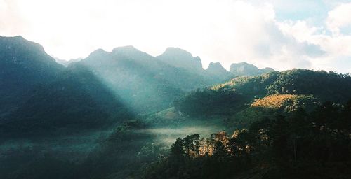 Scenic view of tree mountains against sky