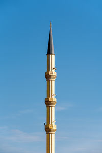 Low angle view of lighthouse against clear blue sky