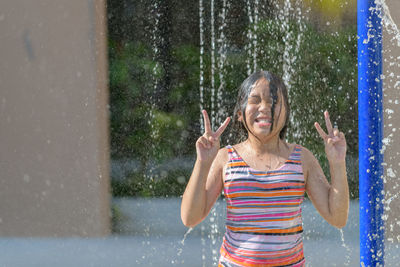 Portrait of a smiling girl standing in water