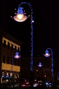 Low angle view of illuminated buildings against sky at night