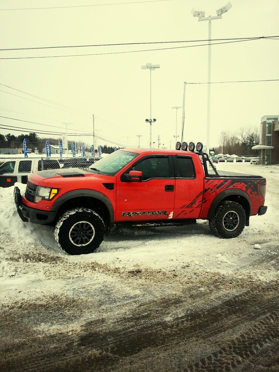 transportation, land vehicle, mode of transport, car, street, stationary, road, travel, day, outdoors, parking, parked, side view, red, on the move, building exterior, vehicle, no people, sand, sky