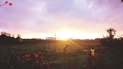 Scenic view of field against sky during sunset