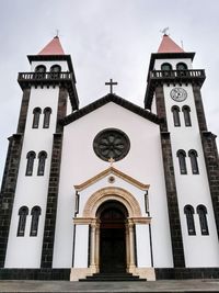 Low angle view of bell tower against sky