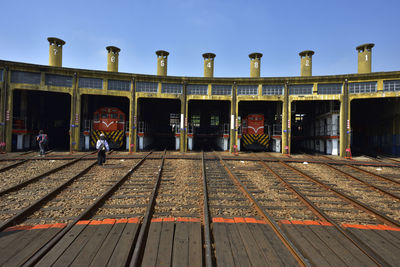 Train at railroad station against clear sky