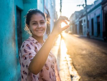 Portrait of a smiling young woman standing outdoors