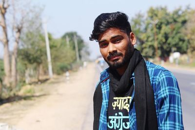 Portrait of young man standing outdoors