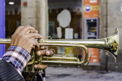 Cropped hands playing trumpet