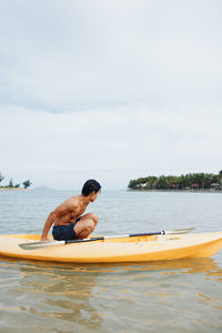 Man kayaking in sea