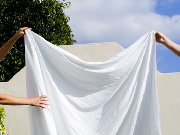 Low angle view of woman standing against sky