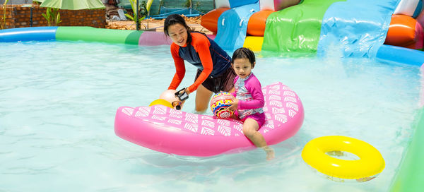 Mother and daughter playing at water park