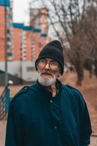 Portrait of man wearing hat standing outdoors