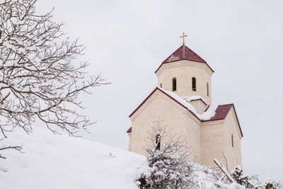Low angle view of bell tower against sky during winter